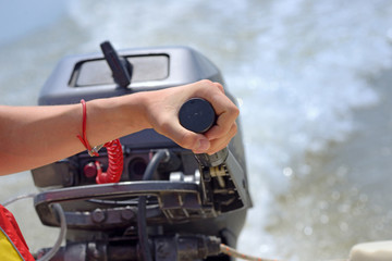 fisherman hand and boat engine