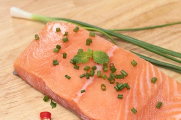 fresh raw salmon fillet on wood background.