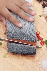 fresh raw salmon fillet on wood background.