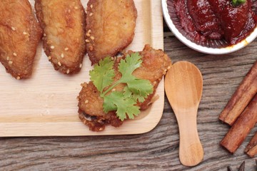 Korean fried chicken is delicious on wood background.