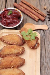 Korean fried chicken is delicious on wood background.