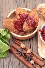 Korean fried chicken is delicious on wood background.