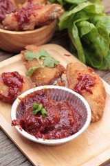 Korean fried chicken is delicious on wood background.