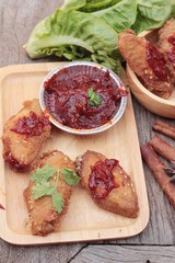 Korean fried chicken is delicious on wood background.