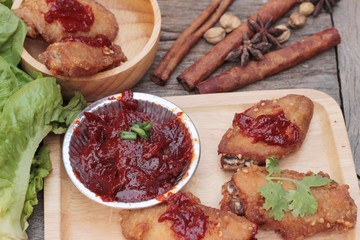 Korean fried chicken is delicious on wood background.