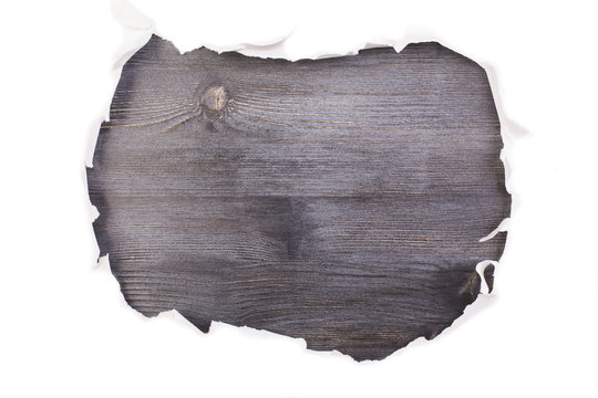 Dark wooden surface torn paper