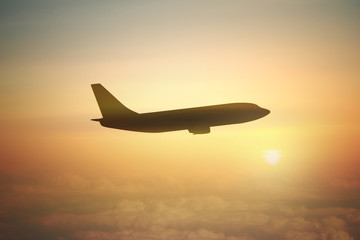 Fototapeta na wymiar Airplane silhouette at sunset
