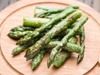 Asparagus sprouts on the wooden tray.