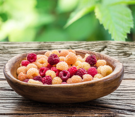 Raspberries in the wooden bowl.