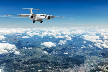 Fototapeta premium Airplane over the clouds.