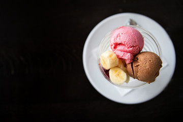 strawberry and chocolate ice cream with banana. View from above