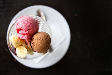 strawberry and chocolate ice cream with banana. View from above
