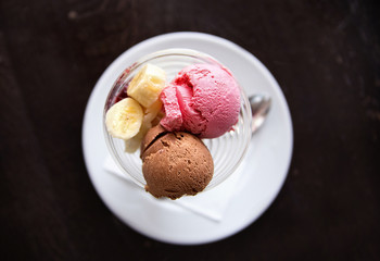 strawberry and chocolate ice cream with banana. View from above