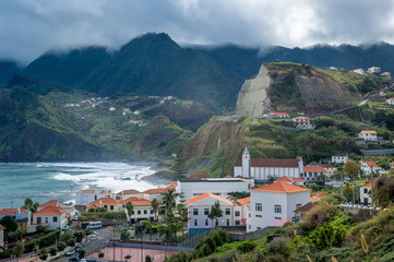 Porto da Cruz town surrounded by volcanic rocks and mountains, Madeira island