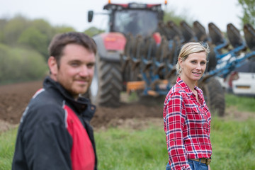 Young farmers with new tractor