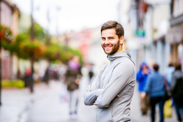 Young hipster man running in town, resting