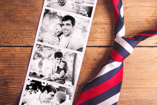 Fathers day composition. Black-and-white photos, tie. Wooden bac