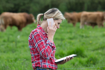 Farmer managing her farm - 111420314