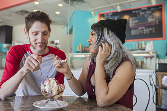 Couple eating ice cream in ice cream parlor