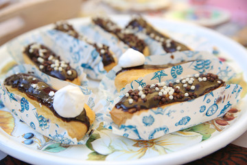 Chocolate eclairs on plate