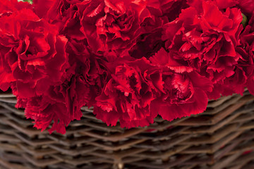 cropped image of red peony on basket