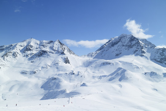 Alpine resort of Les Arcs with ski slopes on snowy French Alps mountains