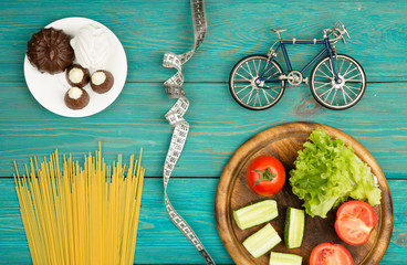 Choice of food: diet, vegetables and sports or cake, candy