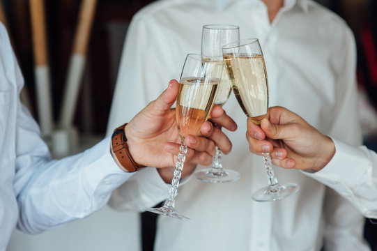 three Successful businessman toasting Champagne