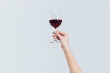 Gordijnen Female hand holding glass with wine © Drobot Dean