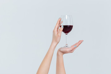 Female hands holding glass with wine