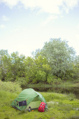 Camping in the woods on the banks of the river.