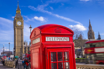 Fototapeta na wymiar London, England - Classic Red Telephone Box and Big Ben and Houses of Parliament with Double Decker bus and blue sky