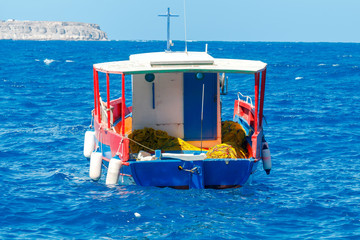 Oia. Fishing boat in the harbor.