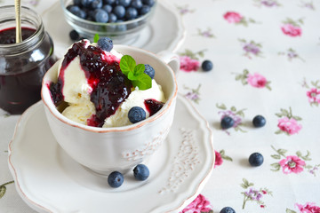 Vanilla ice cream with blueberry jam in a cup