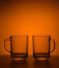 Still-life with tea mugs are not filled on colored background.
