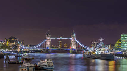Fototapeta na wymiar London, England - The Iconic Tower Bridge and HMS Belfast cruiser ship on River Thames by night
