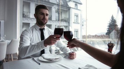 Couple on romantic date in restaurant, focus on man