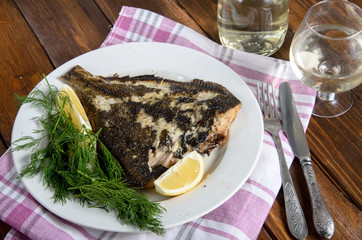 grilled flounder on the white plate