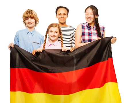 Picture of four teenage kids holding German flag
