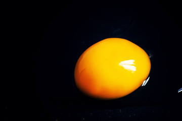 Egg yolk on a dark background, macro shot, selective focus, shal