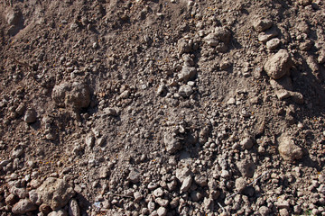 pile the excavated grey brown soil and dirt closeup foreground