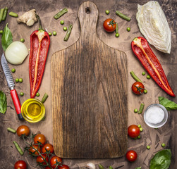 Healthy foods, cooking and vegetarian concept variety of vegetables and fruits are laid out around the cutting board, place for text, top view