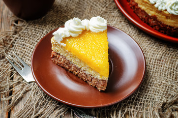 mango cheese cake decorated with whipped cream and mango puree
