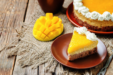 Obraz na płótnie Canvas mango cheese cake decorated with whipped cream and mango puree