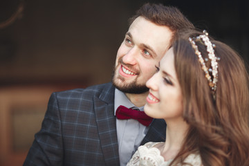 Kissing wedding couple in spring nature close-up portrait