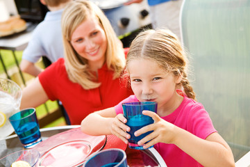 Summer: Girl Drinking Lemonade at Table
