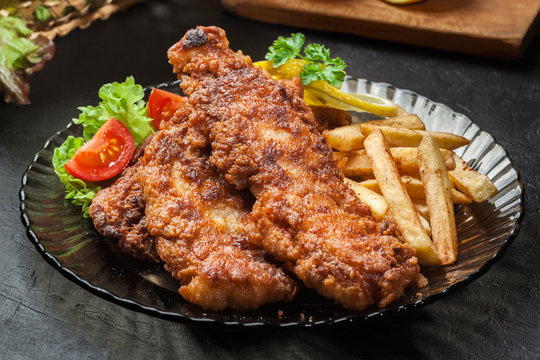 Fried fish in crispy batter with chips