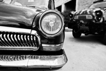 Old vintage car headlight close up. Black and white photo