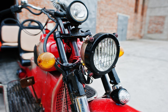 Headlight of old red retro motorcycle