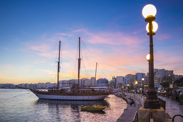 Sliema bay waterfront with sailboat at sunset - Malta